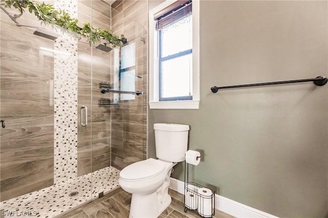 bathroom with toilet and an enclosed shower