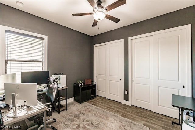 home office featuring ceiling fan and hardwood / wood-style flooring