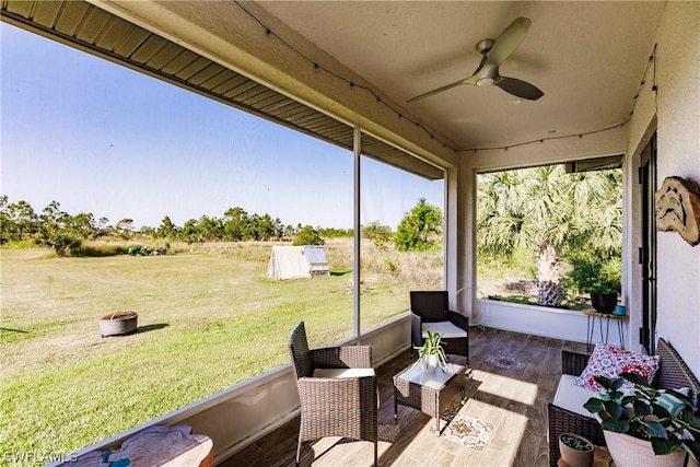 sunroom / solarium featuring ceiling fan