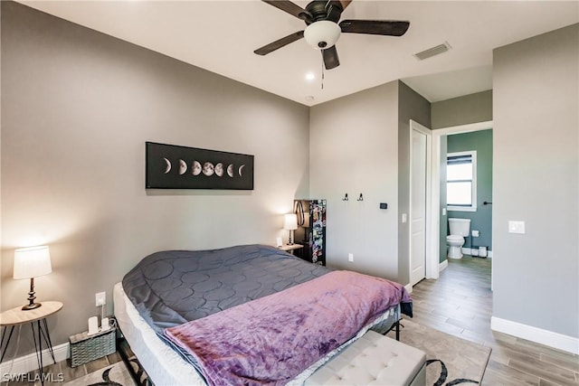 bedroom featuring connected bathroom, hardwood / wood-style flooring, and ceiling fan