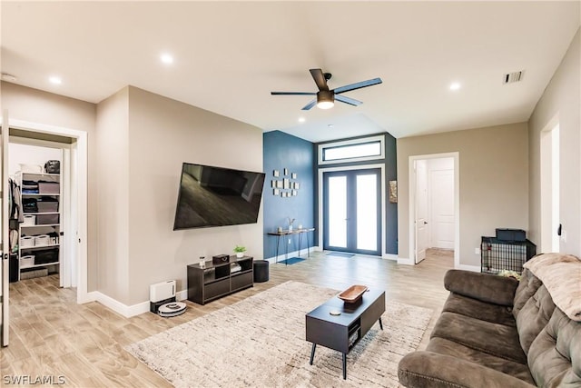 living room featuring ceiling fan, french doors, and light hardwood / wood-style flooring