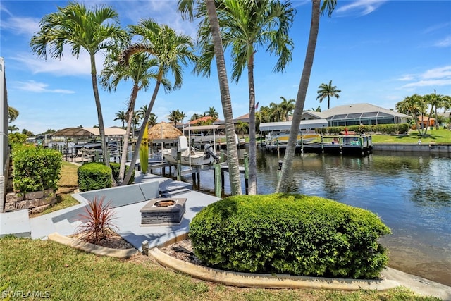 dock area featuring a water view and an outdoor fire pit