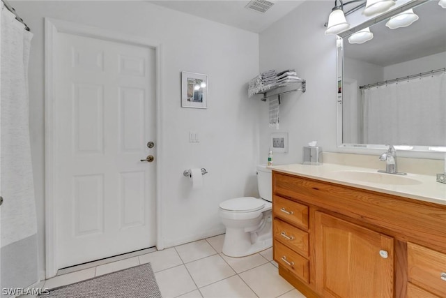 bathroom featuring tile patterned flooring, vanity, and toilet