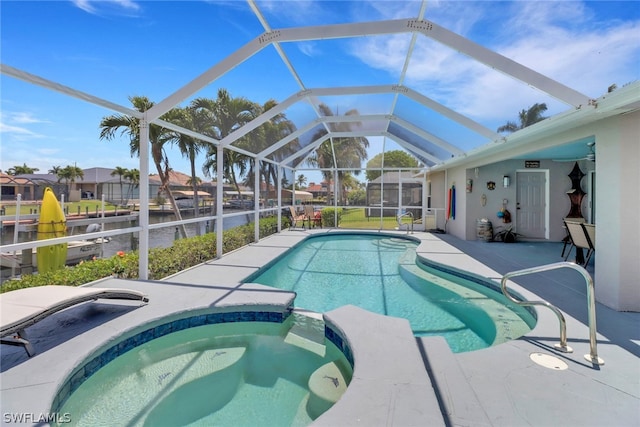 view of swimming pool featuring glass enclosure, an in ground hot tub, and a patio