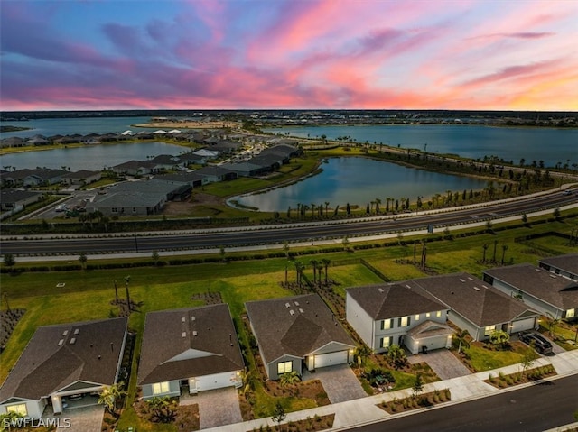 aerial view at dusk with a water view