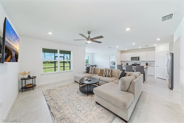 living room featuring ceiling fan and light tile floors