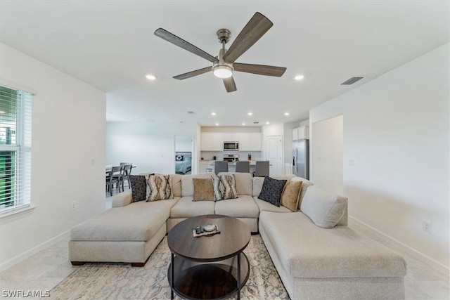 living room featuring ceiling fan and light tile flooring