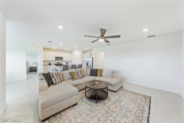 living room with ceiling fan and light tile flooring