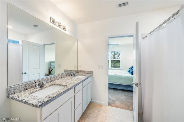 bathroom featuring dual sinks, tile floors, ceiling fan, and large vanity