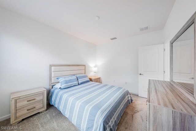 bedroom with light colored carpet