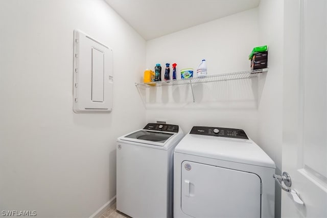 laundry room with light tile floors and washing machine and clothes dryer