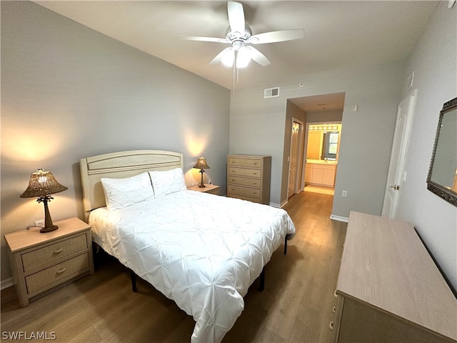 bedroom with wood-type flooring, ceiling fan, and ensuite bathroom