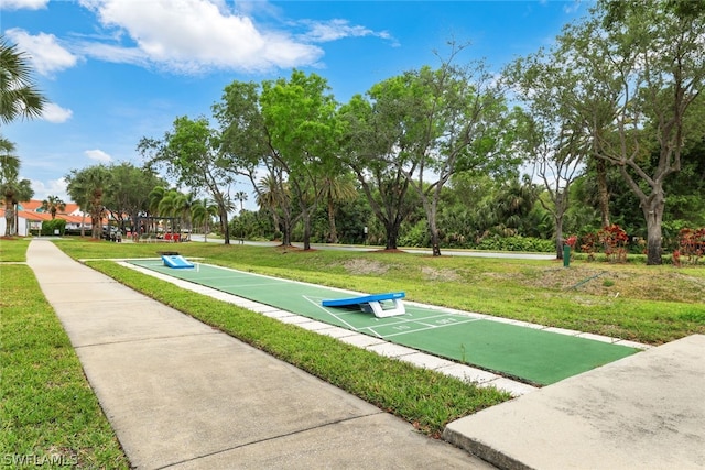 view of property's community with a yard