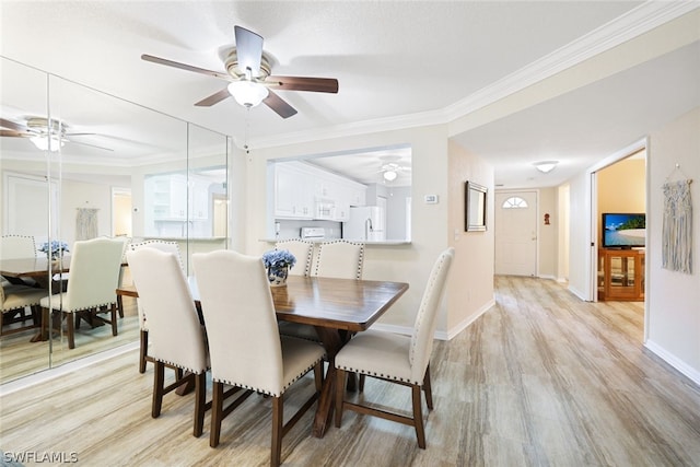 dining area featuring ornamental molding, ceiling fan, and light wood-type flooring