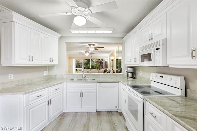 kitchen featuring white appliances, light wood-type flooring, white cabinetry, sink, and ceiling fan