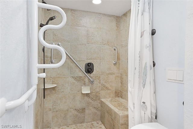 bathroom with a tile shower