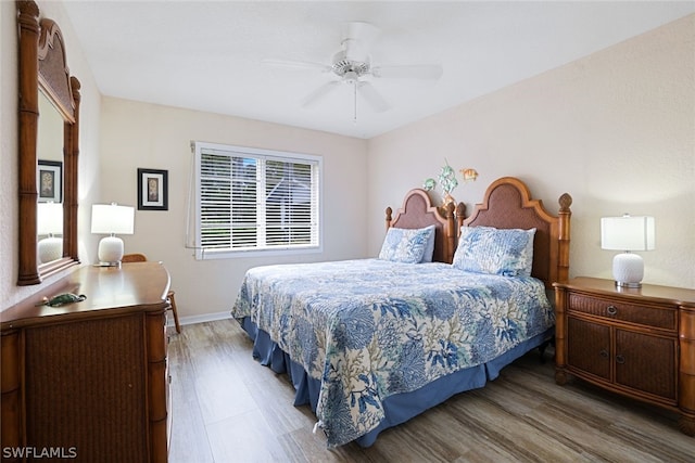 bedroom with ceiling fan and hardwood / wood-style flooring