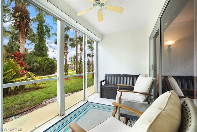 sunroom / solarium featuring ceiling fan