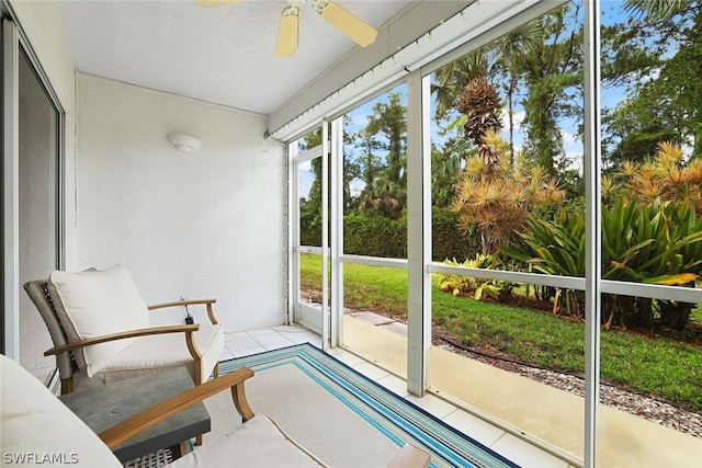 sunroom / solarium featuring ceiling fan