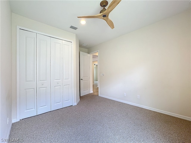 unfurnished bedroom featuring carpet flooring, a closet, and ceiling fan