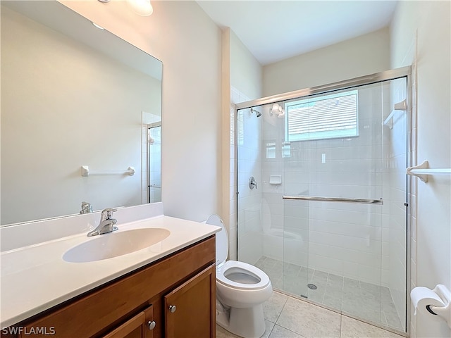 bathroom featuring a shower with shower door, toilet, tile floors, and large vanity