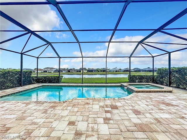 view of swimming pool featuring a patio, a lanai, a water view, and an in ground hot tub