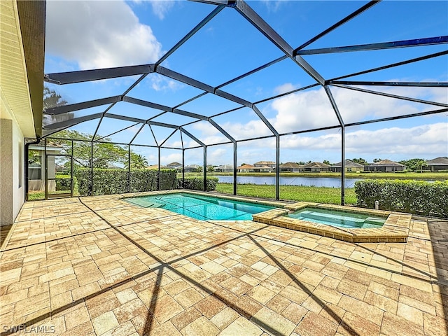 view of pool with a water view, an in ground hot tub, glass enclosure, and a patio