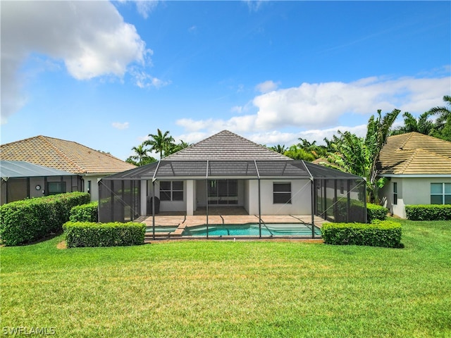 rear view of property with a lanai and a yard