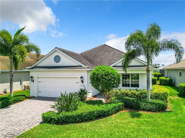 view of front facade with a garage and a front yard