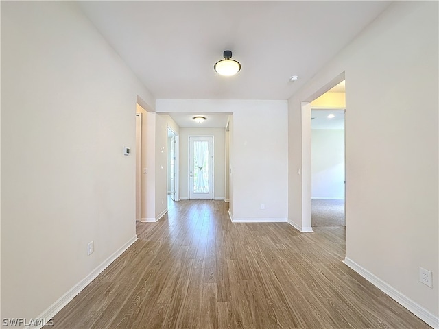 spare room with wood-type flooring