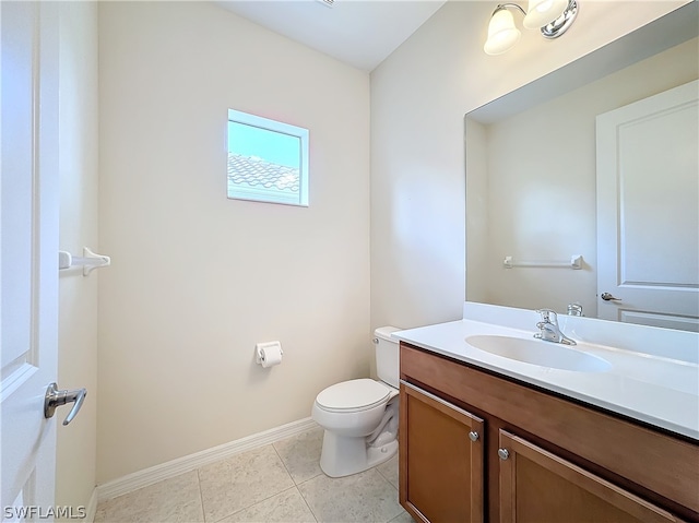 bathroom featuring vanity, tile floors, and toilet