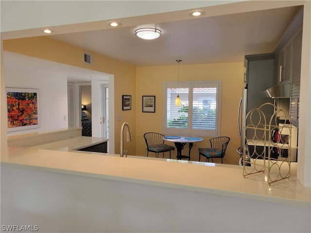 kitchen with kitchen peninsula and decorative light fixtures