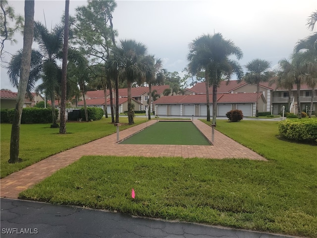 view of property's community with a lawn