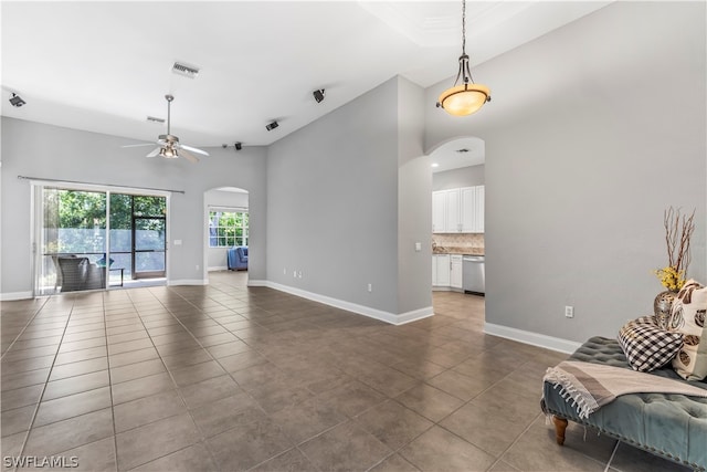 unfurnished living room featuring ceiling fan and tile patterned flooring