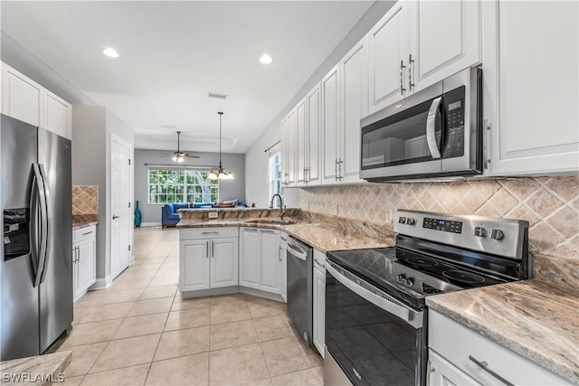 kitchen with pendant lighting, sink, kitchen peninsula, white cabinetry, and appliances with stainless steel finishes