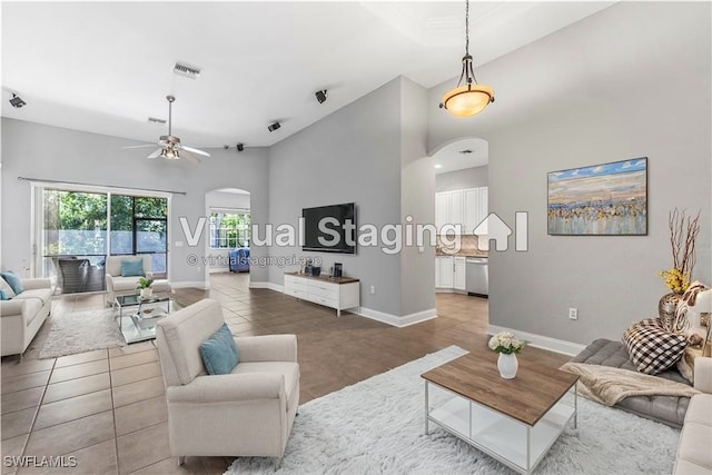 tiled living room with ceiling fan