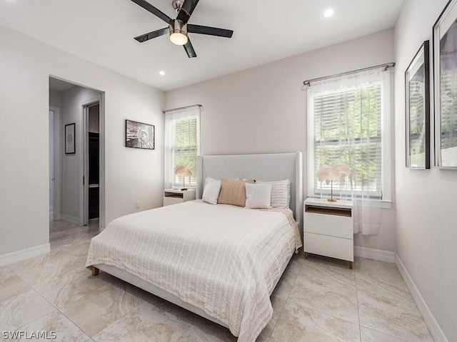 bedroom with ceiling fan and light tile floors