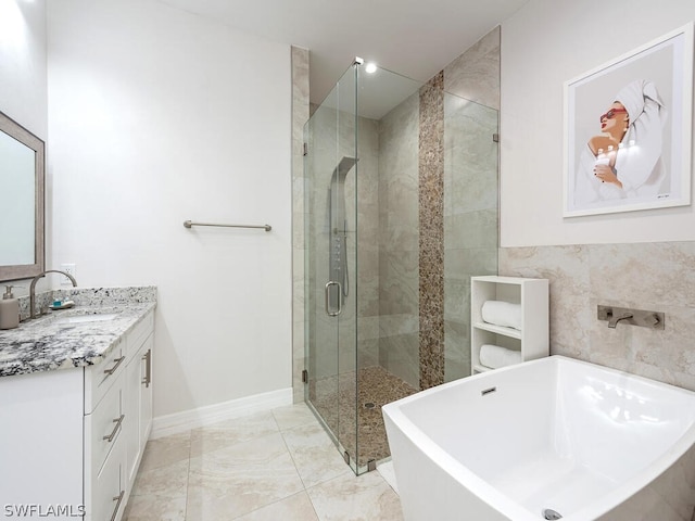 bathroom featuring tile walls, shower with separate bathtub, tile flooring, and vanity