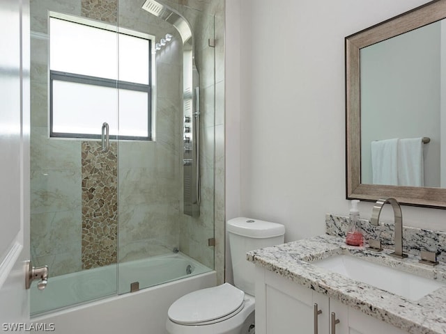 full bathroom with vanity, toilet, and shower / bath combination with glass door