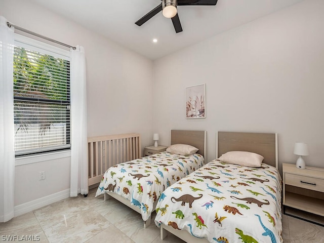 tiled bedroom featuring ceiling fan