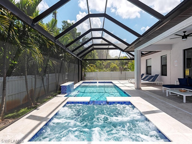 view of swimming pool featuring a lanai, an in ground hot tub, ceiling fan, and a patio area