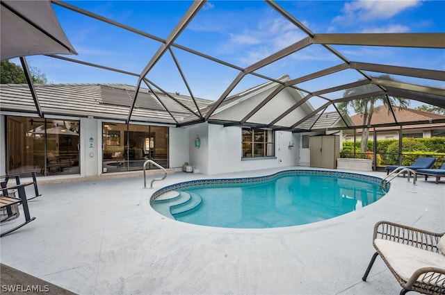 view of pool with a patio area and a lanai