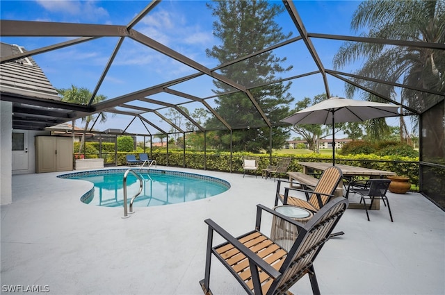 view of swimming pool featuring a patio area and a lanai