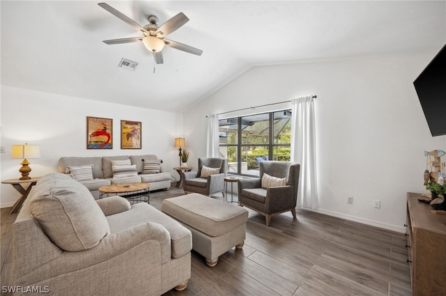 living room featuring vaulted ceiling, ceiling fan, and dark hardwood / wood-style floors