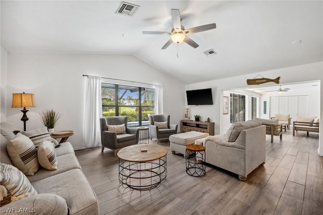 living room featuring vaulted ceiling, ceiling fan, and hardwood / wood-style floors