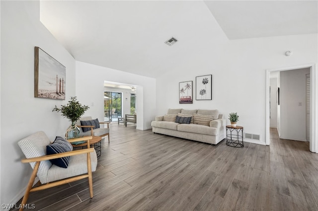 living room with hardwood / wood-style floors and vaulted ceiling