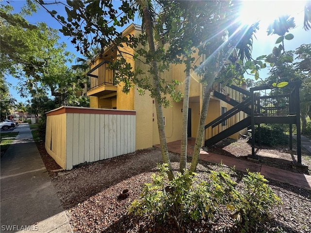 view of side of home featuring a balcony