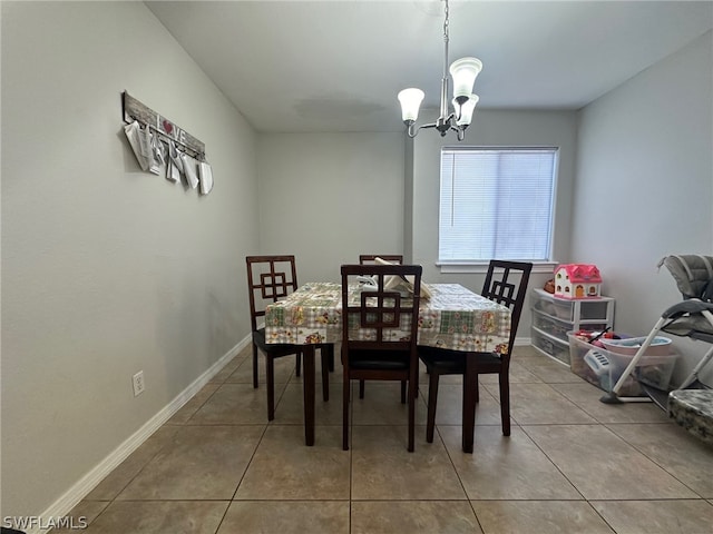 tiled dining area featuring an inviting chandelier