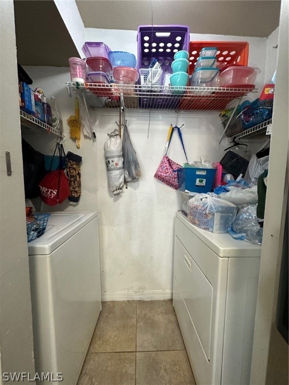 laundry area with washing machine and clothes dryer and tile floors