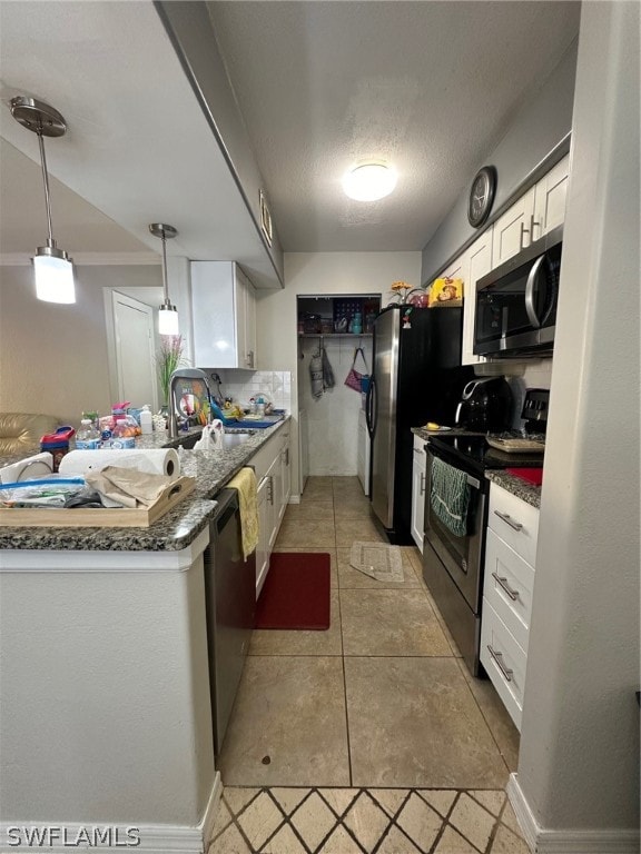 kitchen with stainless steel appliances, white cabinets, sink, pendant lighting, and light tile floors